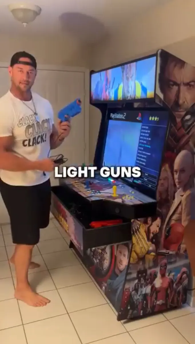 Aaron Reed with the finished Deadpool & Wolverine arcade