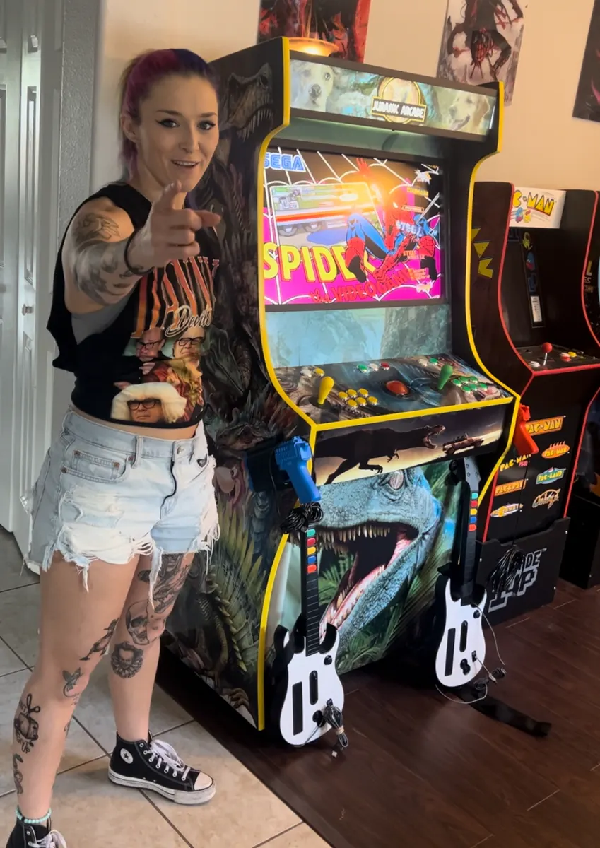 Tegan Nox with the finished Jurassic Arcade arcade