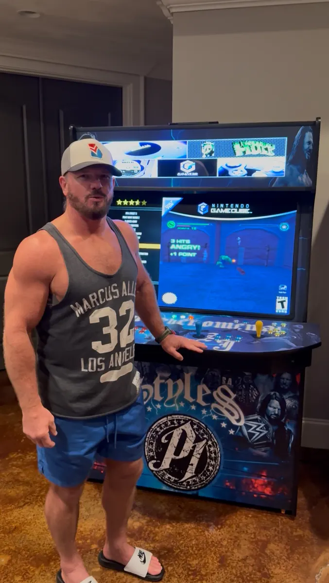 AJ Styles with the finished Phenomenal Arcade arcade